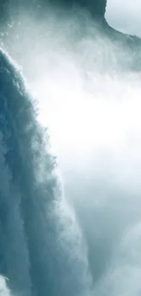 This live wallpaper for your phone showcases a breathtaking scene of a surfer riding a board in front of a stunning waterfall