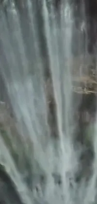 This phone live wallpaper showcases a stunning waterfall with a close-up shot from the top