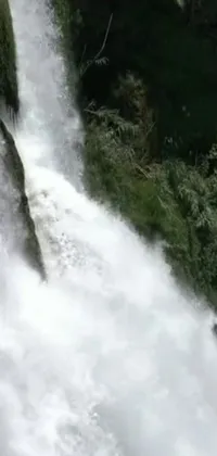 This phone live wallpaper features an exciting scene of a man surfing a colossal waterfall