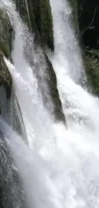 This phone live wallpaper features a captivating image of a person surfing on a massive waterfall wave