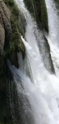 Experience the wild rush of a cascading waterfall with this vibrant phone live wallpaper