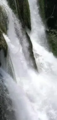 This live wallpaper displays an image of a man surfing on a waterfall wave