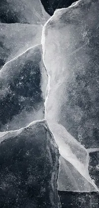 This live wallpaper for your phone features a visually stunning black and white photograph of a broken window captured with microscopic detail