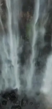 Experience the serenity of a magnificent waterfall with this stunning phone live wallpaper
