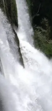 This stunning live wallpaper features an adventurous man surfing a powerful waterfall wave