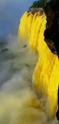 This live wallpaper showcases a beautiful picture of a yellow-colored waterfall inspired by National Geographic