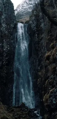 Experience the beauty of nature with our stunning phone live wallpaper! Featuring an enchanting waterfall scene shot from a 50-feet distance, this wallpaper captures the essence of Scottish folklore with its mystical aura and features artful elements of hurufiyya