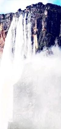 This live wallpaper features a stunning waterfall displaying its natural beauty with a group standing in front of it