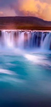 This phone live wallpaper boasts a mesmerizing waterfall cascading into a serene body of water