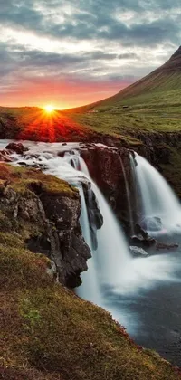 This live phone wallpaper features a soothing waterfall set against a stunning sunset backdrop