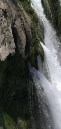 Experience the beauty of nature with this stunning phone live wallpaper featuring a breathtaking waterfall