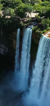 This live phone wallpaper showcases a stunning waterfall surrounded by lush greenery