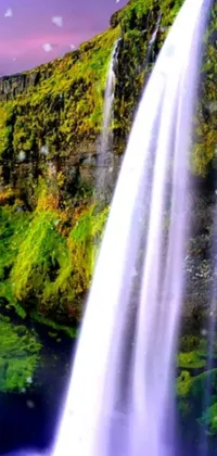 This live phone wallpaper features a breathtaking waterfall surrounded by green hills