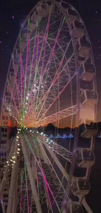 This phone live wallpaper features a breathtaking 3D animation of a large ferris wheel hovering above a serene lake