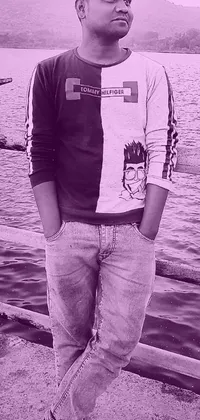 This phone live wallpaper features a captivating black and white photo of a young male in a purple hoodie by a peaceful body of water