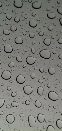 This live wallpaper features a high-definition close-up view of water droplets on a sleek metal panel-like surface