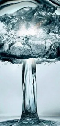 This phone live wallpaper depicts a spectacular nuclear explosion with a mushroom cloud rising from a serene body of water