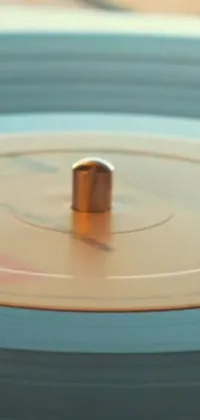 This phone live wallpaper showcases a vintage vinyl record spinning on a wooden table