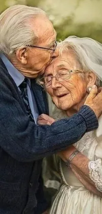 This live phone wallpaper showcases a sweet image of a senior couple hugging each other tenderly