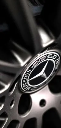 This phone live wallpaper showcases a close-up view of a Mercedes car wheel with stunning graphics