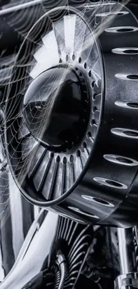 Experience the futuristic beauty of this motorcycle propeller live wallpaper on your phone! This stunning kinetic art features a close-up shot of a propeller against black wheel rims, with intricate guilloche patterns adding texture to the monochrome design