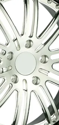 This phone live wallpaper features a close-up shot of a chrome wheel set against a white background