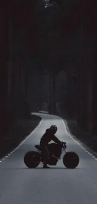 Looking for an adrenaline-pumping live wallpaper for your phone? Check out this exciting design featuring a motorcycle cruising down a winding road at night