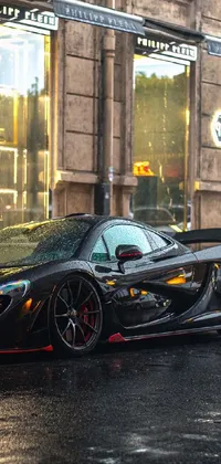 This phone live wallpaper showcases a realistic picture of a stunning black sports car parked on a Parisian street, with drip effects suggesting it may have rained
