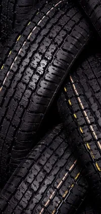 This phone live wallpaper features a stunning digital rendering of tires stacked on each other
