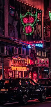 This city street live wallpaper is filled with vibrant, glowing neon signs in shades of pink, blue, green, and purple