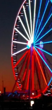 Looking for a breathtaking live wallpaper that captures the excitement of a carnival ride? Look no further than this fabulous phone wallpaper! Featuring a giant ferris wheel set against a beautiful body of water, this vivid and high-resolution wallpaper will transport you to the heart of the carnival