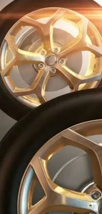 Looking for a sleek and dynamic phone live wallpaper that will showcase your love for all things automotive? Check out this digital rendering of a gold-silver, photorealistic pair of wheels stacked atop each other, aptly named Ixion's Wheel