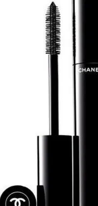 This live phone wallpaper features a chic bottle of Chanel mascara and brush silhouette in black and white