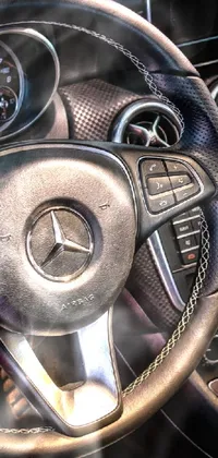 This live wallpaper showcases a highly-detailed 3D image of a luxurious Mercedes-Benz car's interior, featuring a close-up of a beautifully crafted steering wheel