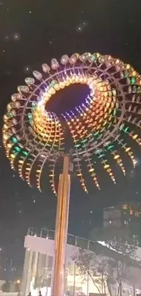 This phone live wallpaper depicts a cityscape at night with a towering ferris wheel as the centerpiece