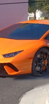 Get ready to rev up your phone's style with this bold and eye-catching live wallpaper featuring an orange sports car parked in a busy lot