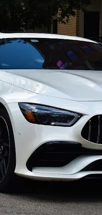 This live wallpaper features a white Mercedes parked in front of a building