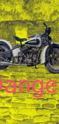 This dynamic phone live wallpaper features a motorcycle against a brick wall, designed in a vibrant colorized photograph style and inspired by a panfuturistic aesthetic