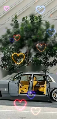 This live wallpaper features a luxurious and powerful silver car parked on the side of the road