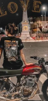 Looking for a dynamic live wallpaper for your phone? Look no further than this bold design featuring a woman on a red motorcycle in front of a temple