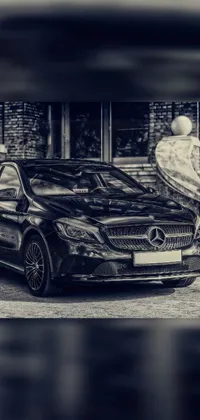 This stunning phone live wallpaper features a black and white photograph of a Mercedes Benz parked in front of a beautiful baroque building