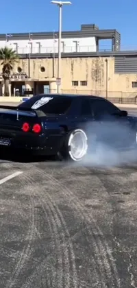 Rev up your home screen with this live wallpaper featuring a JDM car emitting smoke as it speeds through the streets