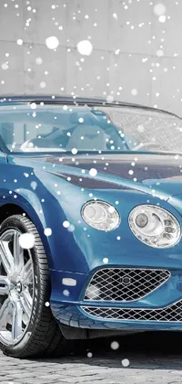 This phone live wallpaper showcases a digitally rendered blue Bentley car parked in front of a building