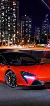 This dynamic phone live wallpaper showcases a vibrant red McLaren sports car set against a distinctive Australian cityscape at night