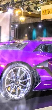 This funky phone live wallpaper showcases a purple Lamborghini Veneno sports car on display in a sleek showroom