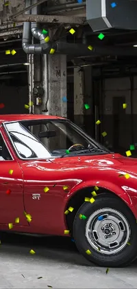 This live wallpaper features a vintage red car parked in a stonework garage