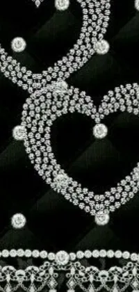 This stunning phone live wallpaper showcases a black and white photograph of two hearts featuring glistening crystals and diamonds