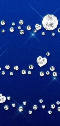 This live wallpaper features a stunning design of diamonds on top of a blue surface, complemented by falling hearts, beaded curtains, star crystals, blue marble patterns, and glittering particles