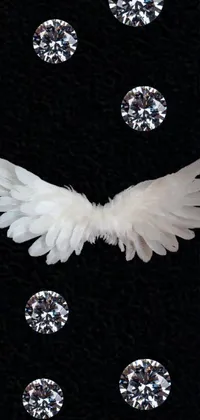 This live phone wallpaper showcases a stunning black background adorned with a captivating design of white angel wings, sparkling diamonds and sleek, modern shapes