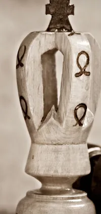 Experience the beauty of fine art with this phone live wallpaper featuring a close-up shot of a vase on a table with a queen chess piece in a retro stylized pyrography art against a blurred background and bokeh effect